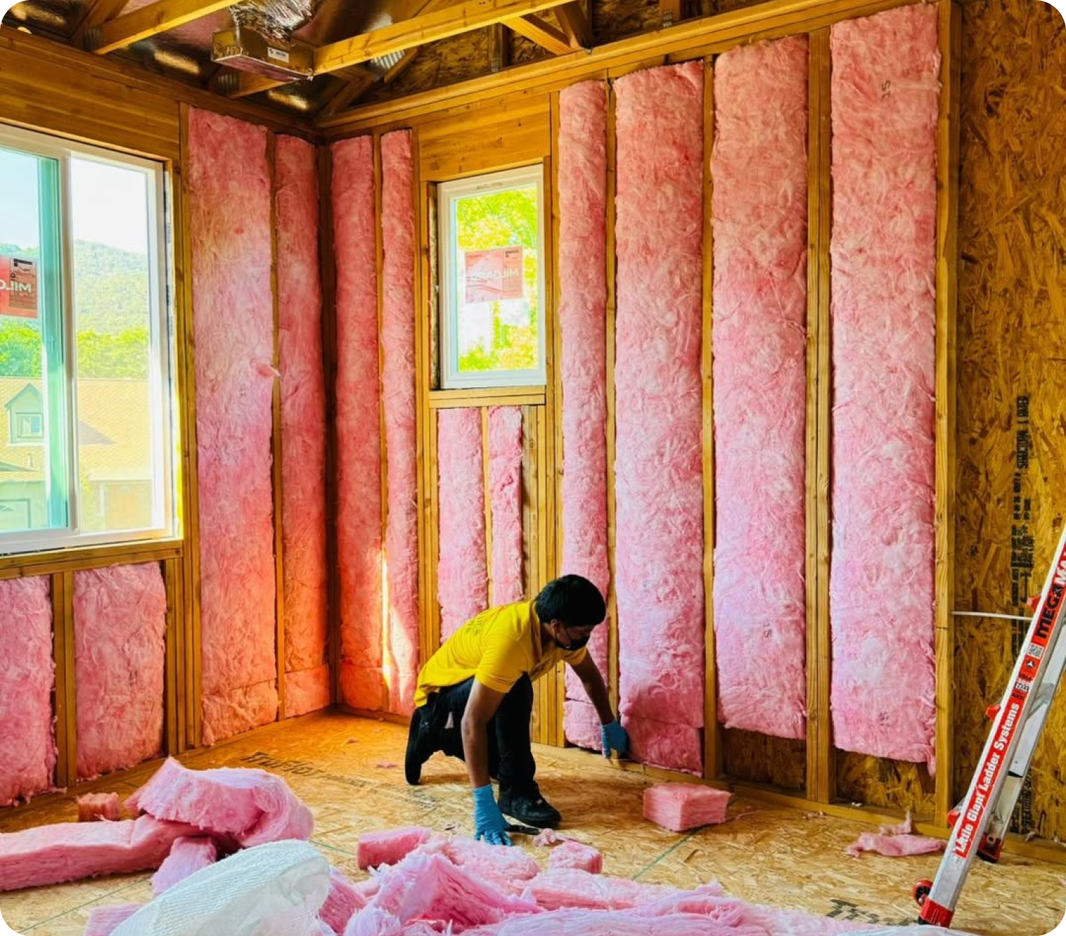 American Attics technician installing insulation in a Bay Area home